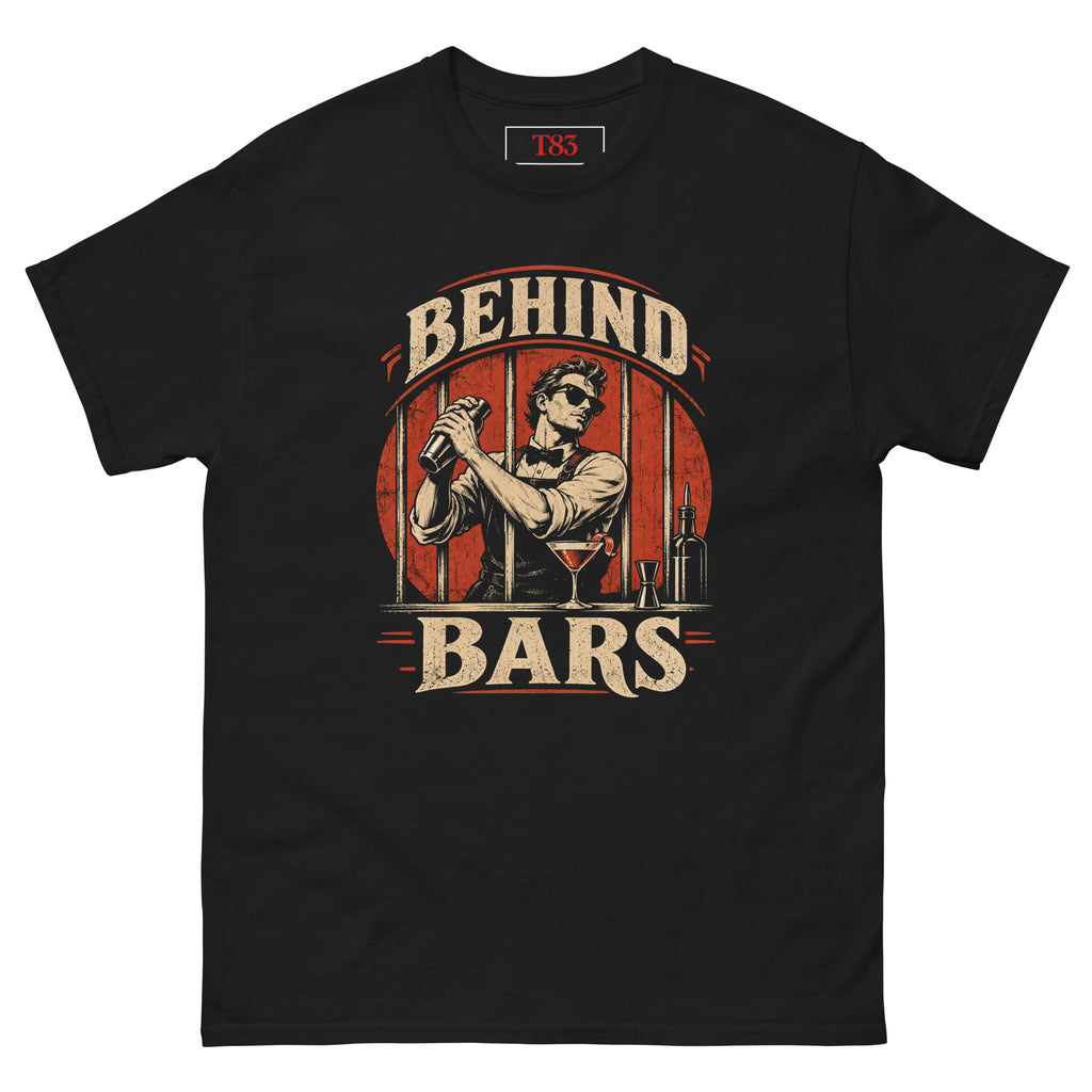 Behind Bars tee, black, front: vintage illustration of a bartender in sunglasses shaking a cocktail behind jail bars on a red circle, distressed cream BEHIND BARS lettering