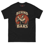 Behind Bars tee, black, front: vintage illustration of a bartender in sunglasses shaking a cocktail behind jail bars on a red circle, distressed cream BEHIND BARS lettering