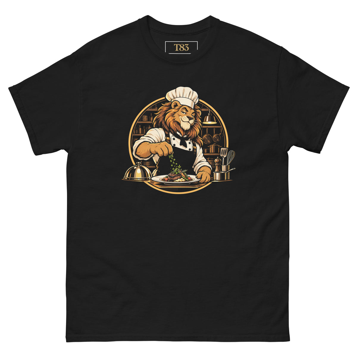 King of the Kitchen tee, black, front: illustration of a lion chef in a toque garnishing a plated steak, framed by a gold circle with copper pans and kitchen shelves