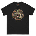 Dead on My Feet Barista tee, black, front: illustration of a grinning zombie barista in a leather apron pouring latte art, framed by a copper circle with an espresso machine, grinder and jars of coffee beans