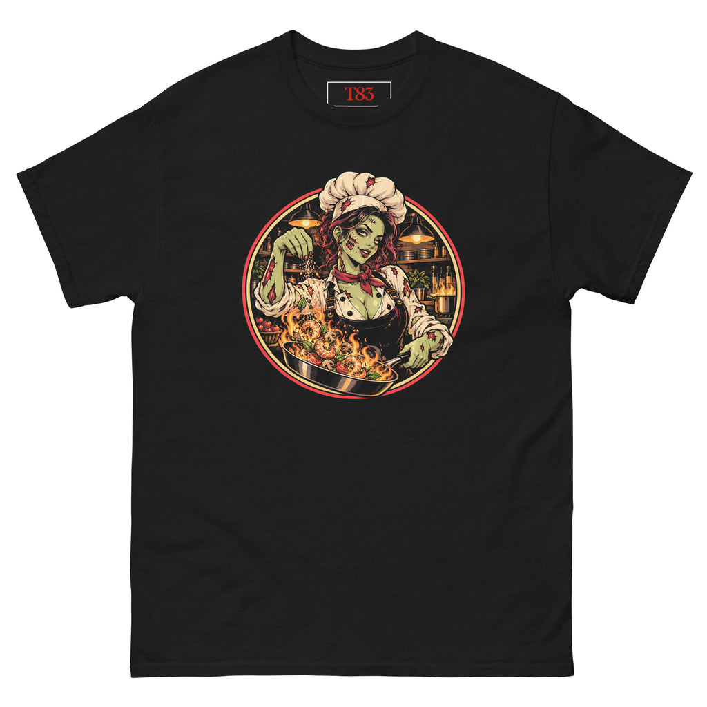 Dead on My Feet Chef (Her) tee, black, front: illustration of a zombie chef in a toque and red neckerchief seasoning a flaming pan of prawns, framed by a red and cream circle with a kitchen behind