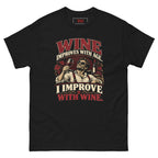 I Improve with Wine tee, black, front: WINE IMPROVES WITH AGE. I IMPROVE WITH WINE. in burgundy and cream lettering around an illustration of a man in sunglasses raising a glass of red wine, with vines, grapes and a bottle