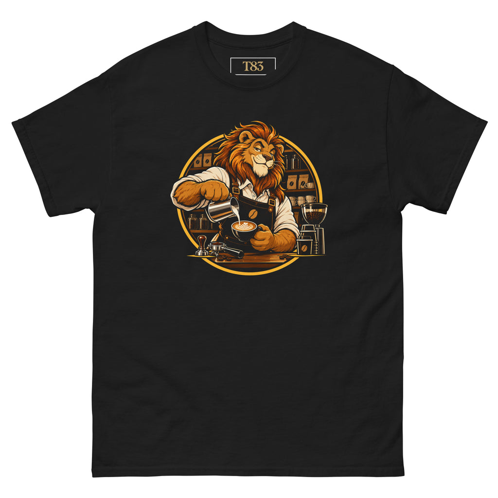 King of the Grind tee, black, front: illustration of a lion barista in a brown apron pouring latte art into a cup, with tamper, portafilter and grinder, framed by a gold circle with shelves of coffee bags behind
