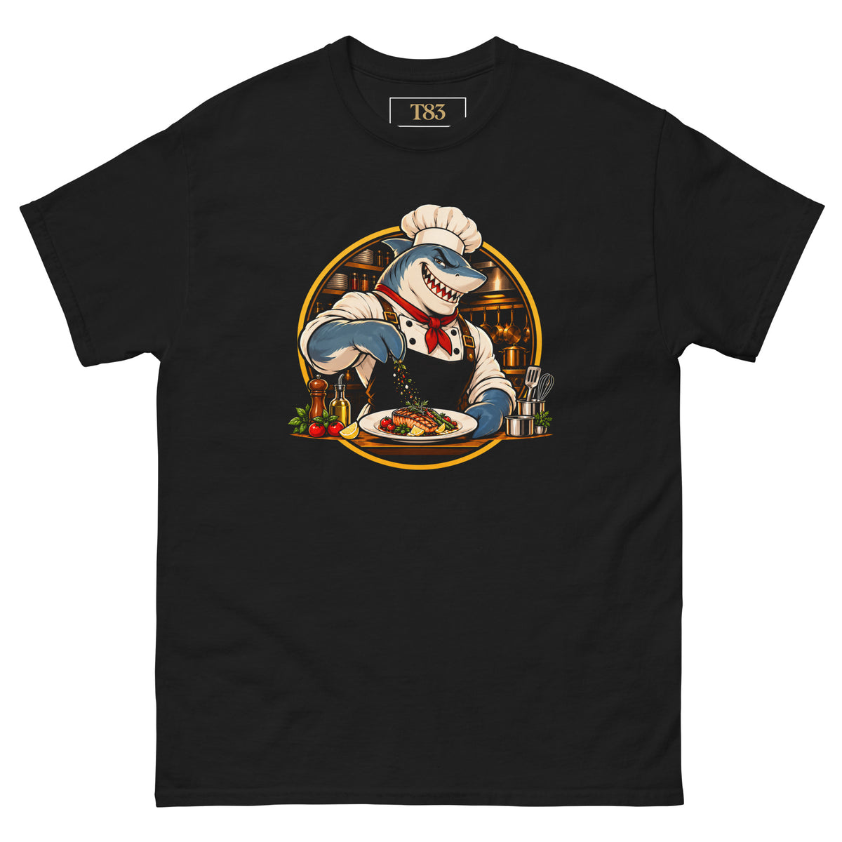 Kitchen Shark tee, black, front: illustration of a grinning shark chef in a toque and red neckerchief seasoning a plate of grilled salmon, framed by a gold circle with copper pans behind